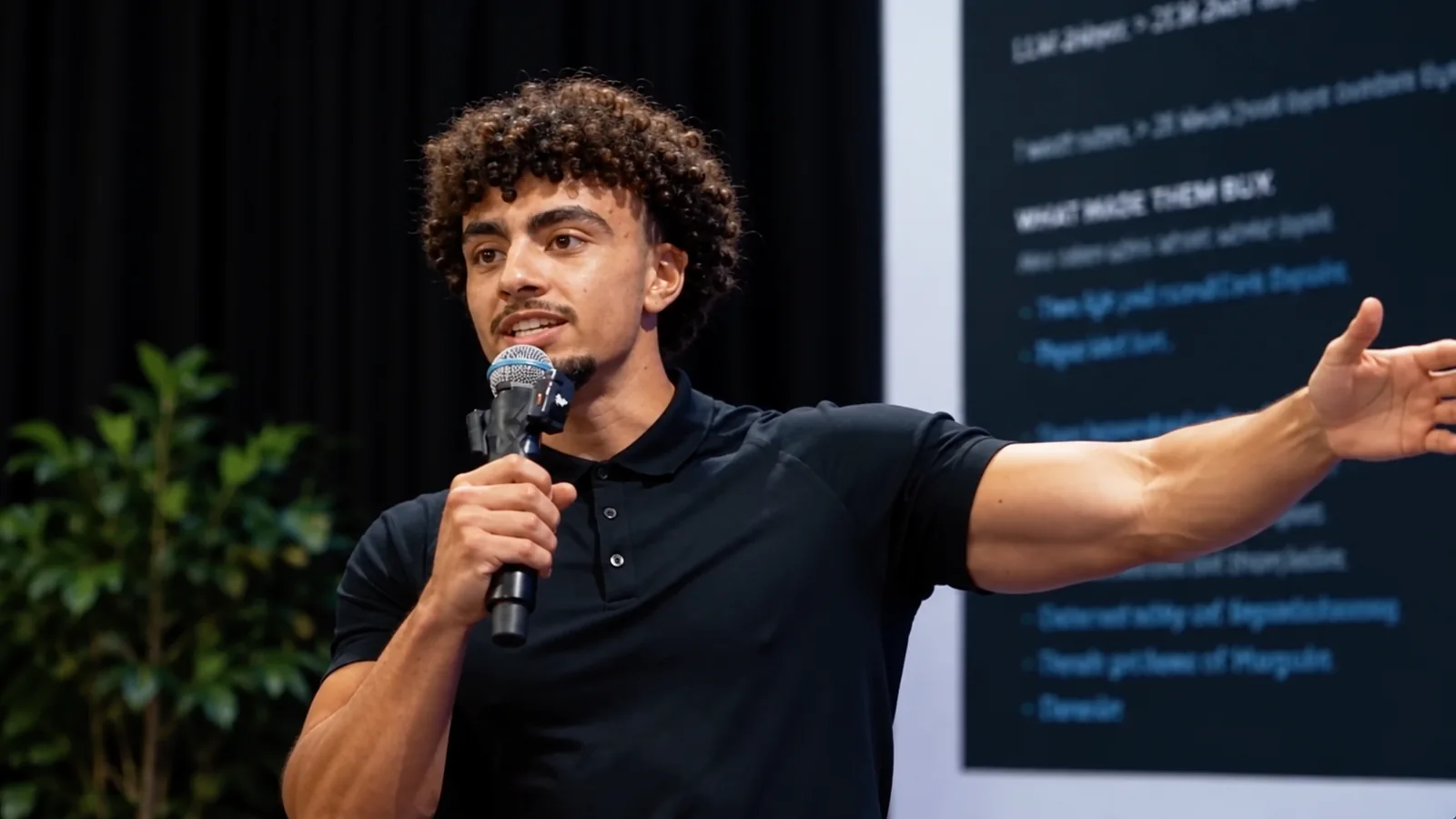 Yasin Said speaking into a microphone